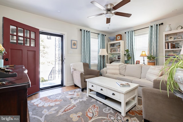 living room featuring hardwood / wood-style floors, a healthy amount of sunlight, and ceiling fan