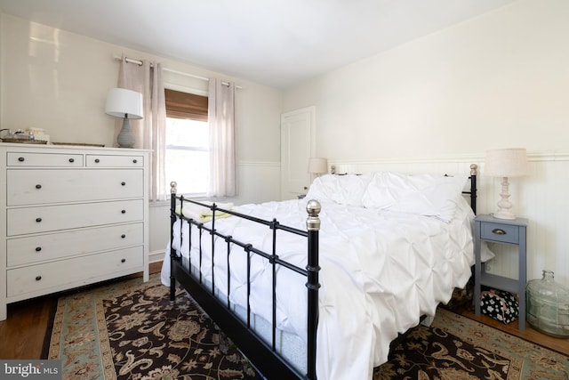 bedroom with dark wood-type flooring