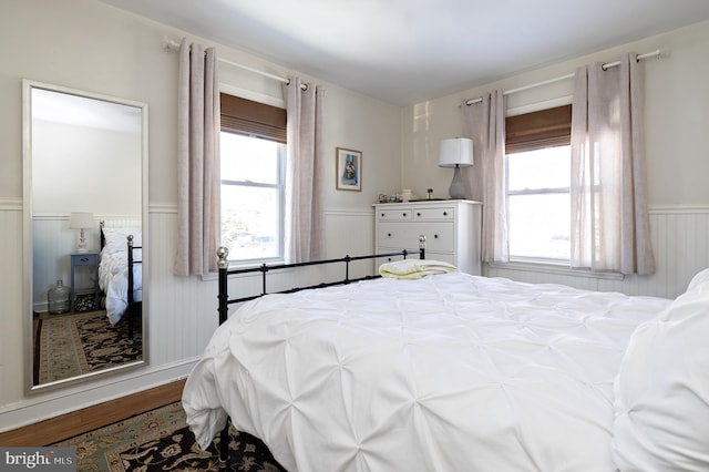 bedroom featuring multiple windows and light wood-type flooring