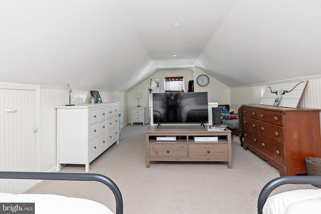 carpeted bedroom with lofted ceiling