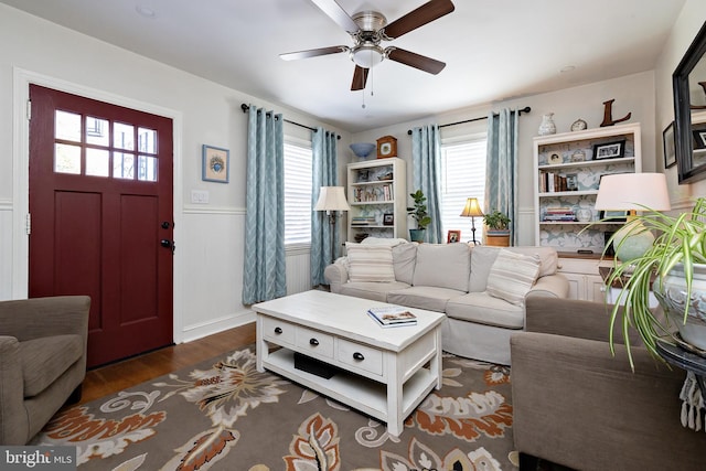 living room featuring ceiling fan, a healthy amount of sunlight, and dark hardwood / wood-style flooring