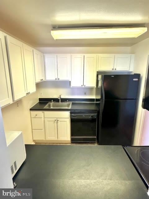 kitchen with white cabinetry, sink, and black appliances