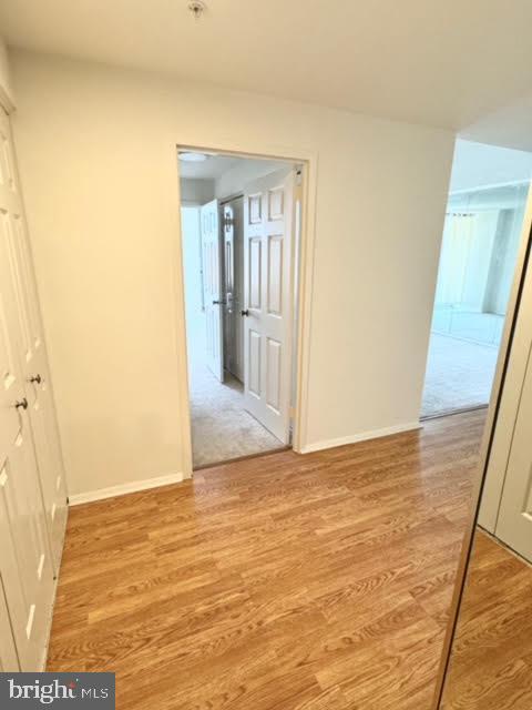 corridor with light wood-type flooring