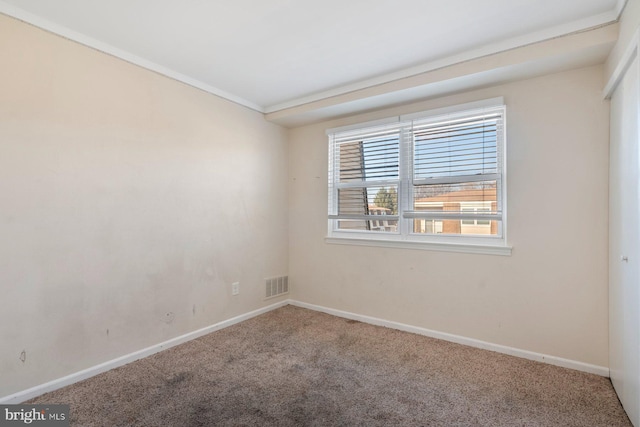 empty room with carpet floors and crown molding