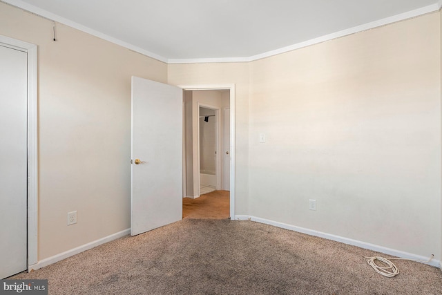 unfurnished room with carpet floors and crown molding