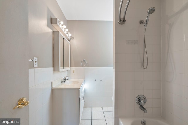 bathroom with tile patterned floors, tiled shower / bath, and vanity