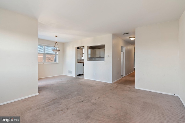 unfurnished living room featuring light carpet