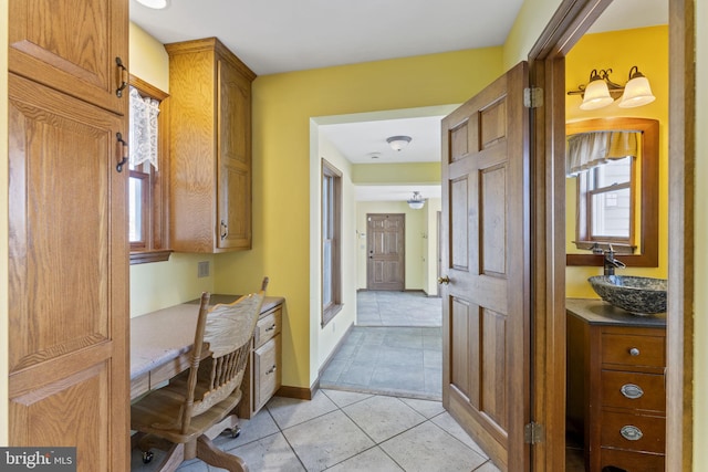 bathroom with vanity, a healthy amount of sunlight, and tile patterned flooring