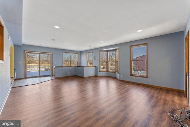 unfurnished living room featuring dark wood-type flooring