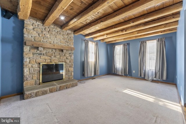 unfurnished living room featuring wooden ceiling, carpet flooring, beamed ceiling, and a fireplace