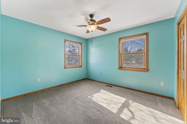 unfurnished room featuring ceiling fan and carpet floors