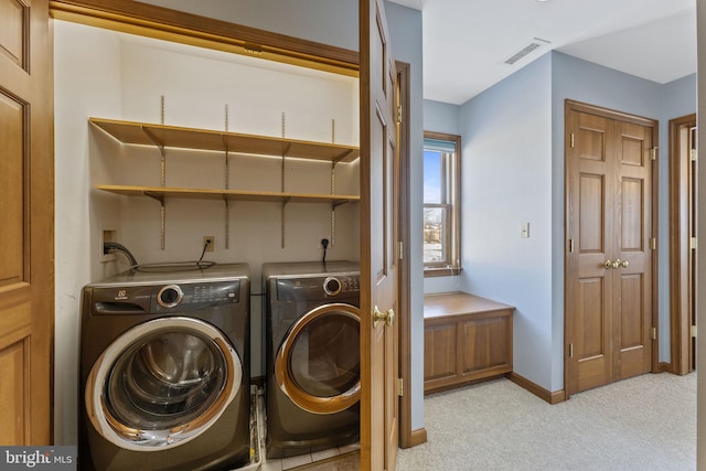 laundry room with light colored carpet and washing machine and dryer