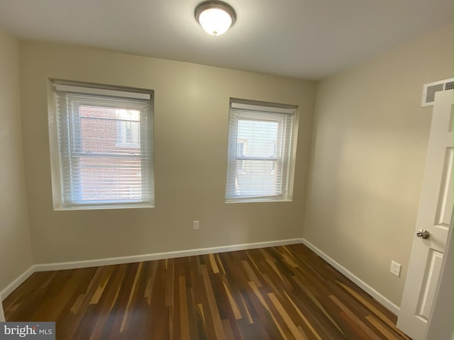 spare room featuring dark hardwood / wood-style floors