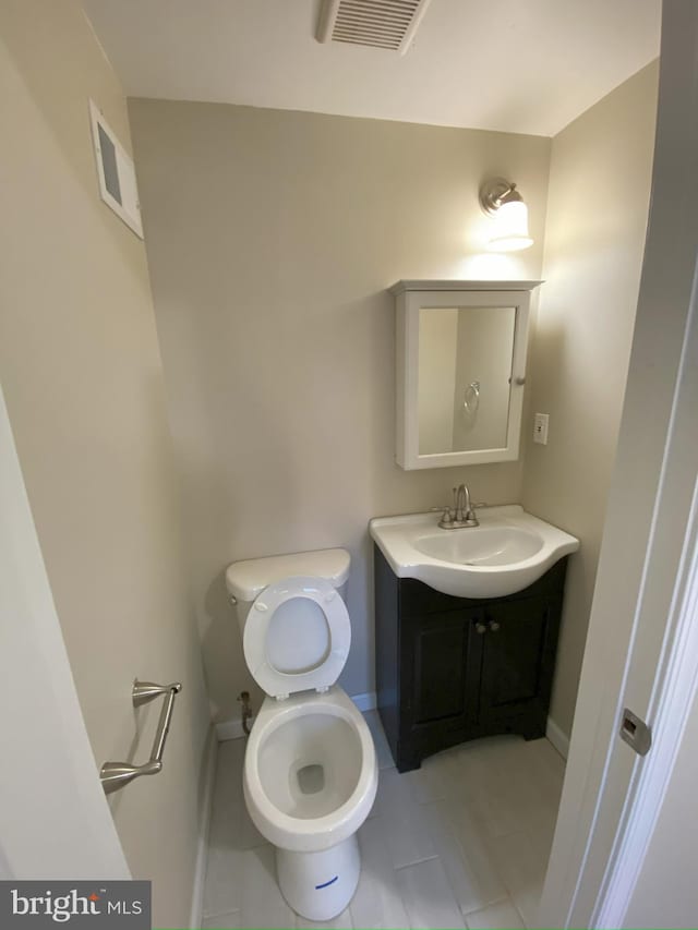 bathroom with tile patterned floors, toilet, and vanity