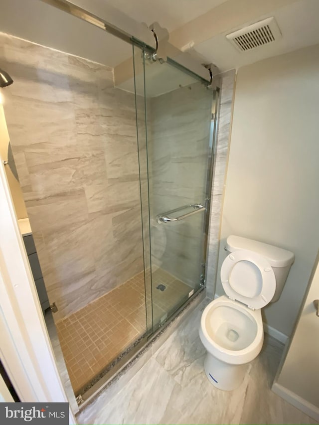 bathroom with toilet and walk in shower