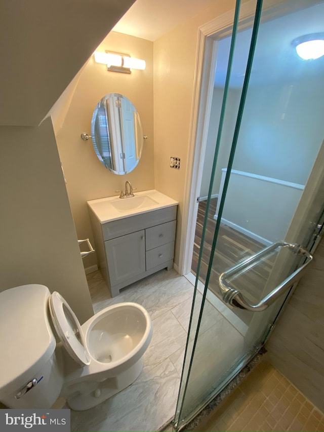 bathroom featuring toilet and vanity