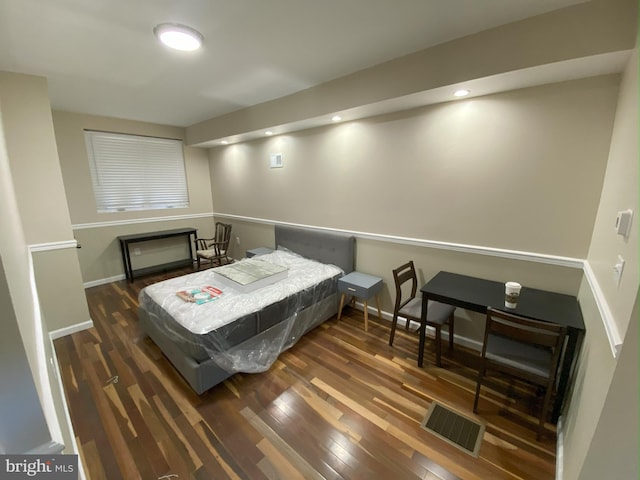 bedroom with dark wood-type flooring