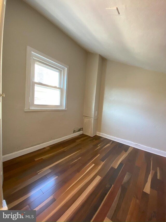 bonus room with dark wood-type flooring