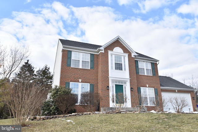 view of front facade with a garage and a front lawn