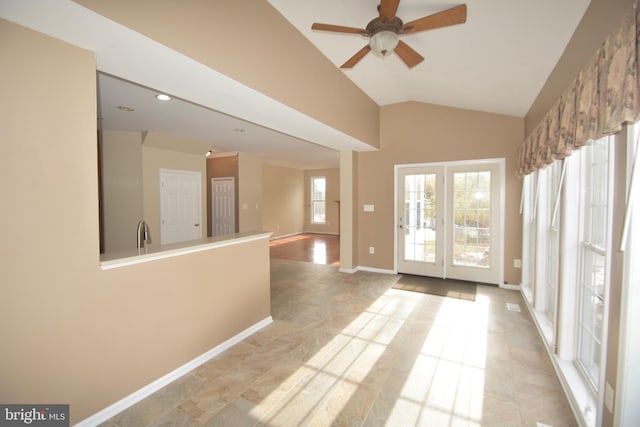 interior space featuring ceiling fan, sink, and vaulted ceiling