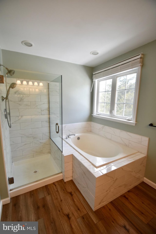 bathroom featuring independent shower and bath and hardwood / wood-style floors