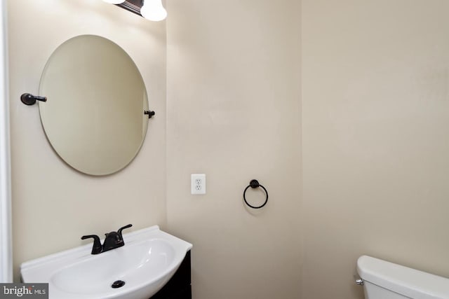 bathroom featuring toilet and vanity