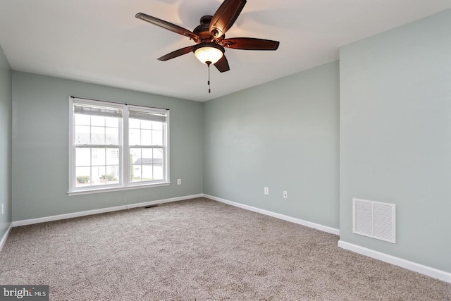 carpeted spare room with ceiling fan