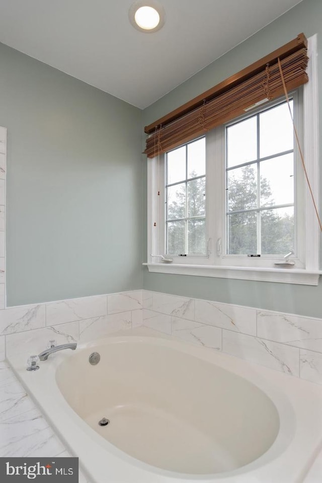 bathroom featuring a relaxing tiled tub