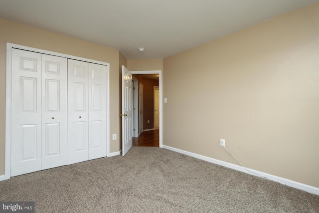 unfurnished bedroom featuring a closet and carpet