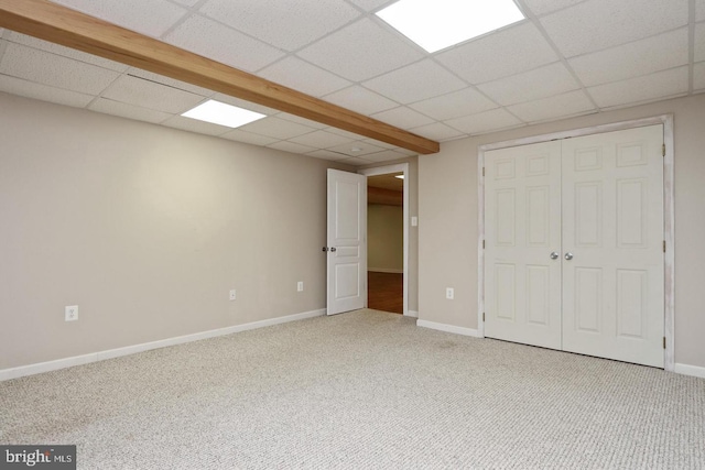 interior space featuring carpet and a drop ceiling