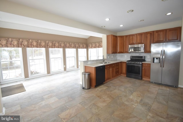 kitchen featuring sink, stainless steel appliances, and decorative backsplash