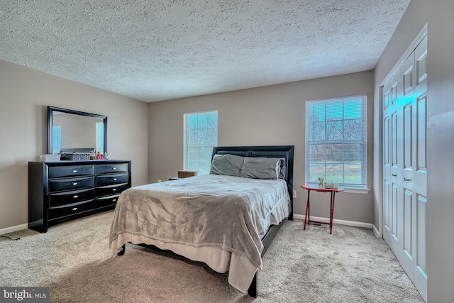 bedroom featuring carpet and a textured ceiling