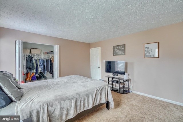 bedroom featuring carpet flooring, a closet, and a textured ceiling