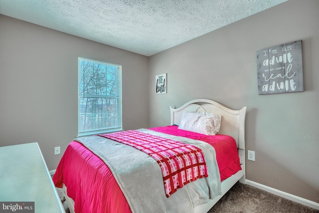 carpeted bedroom with a textured ceiling