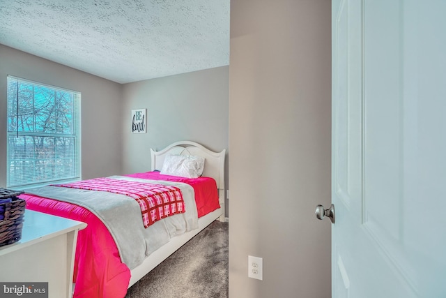 bedroom featuring carpet floors and a textured ceiling