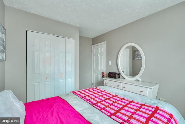 bedroom with a closet and a textured ceiling