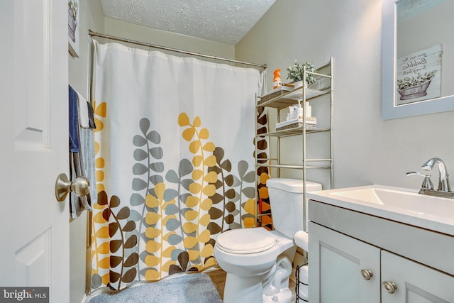 bathroom featuring vanity, walk in shower, a textured ceiling, and toilet