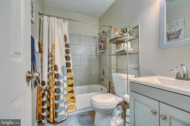 full bathroom with shower / tub combo with curtain, vanity, toilet, and a textured ceiling