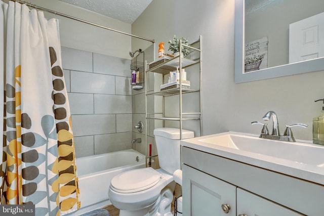 full bathroom with shower / bath combination with curtain, vanity, toilet, and a textured ceiling