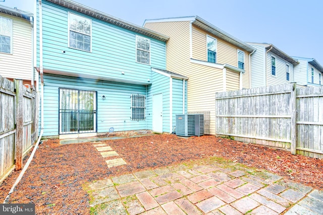 rear view of house with a patio and central air condition unit