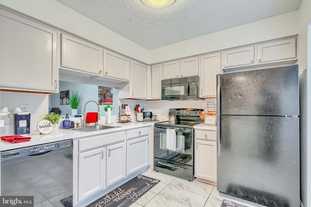 kitchen with sink, black appliances, white cabinets, and a textured ceiling