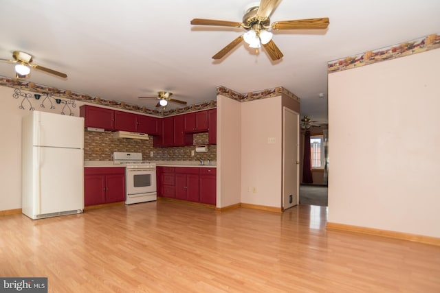 kitchen with white appliances, tasteful backsplash, sink, light wood-type flooring, and ceiling fan