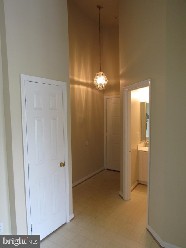 hallway featuring a towering ceiling