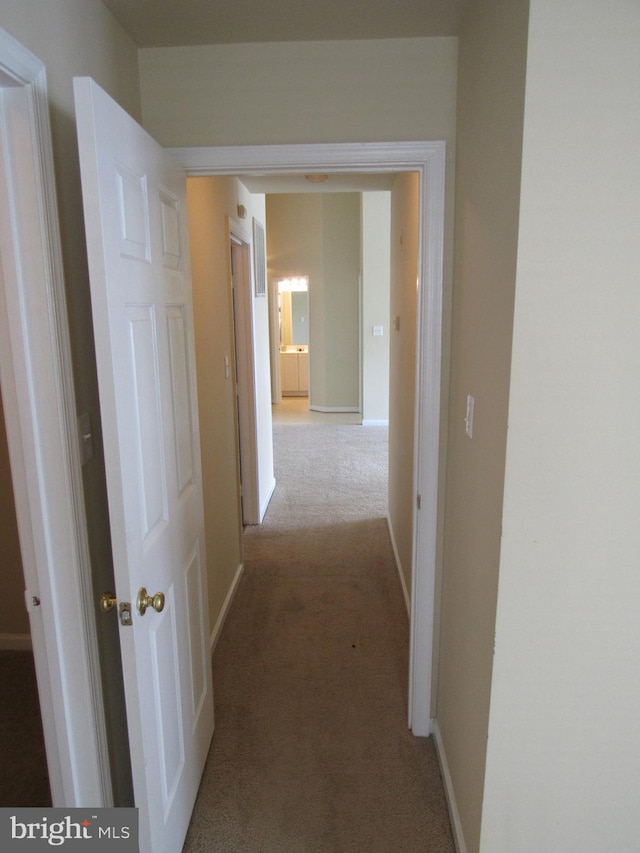 hallway featuring light carpet