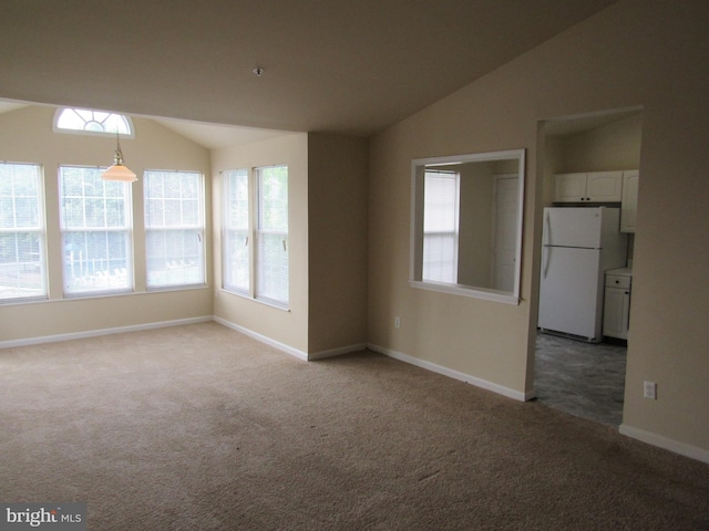 empty room featuring lofted ceiling and carpet flooring