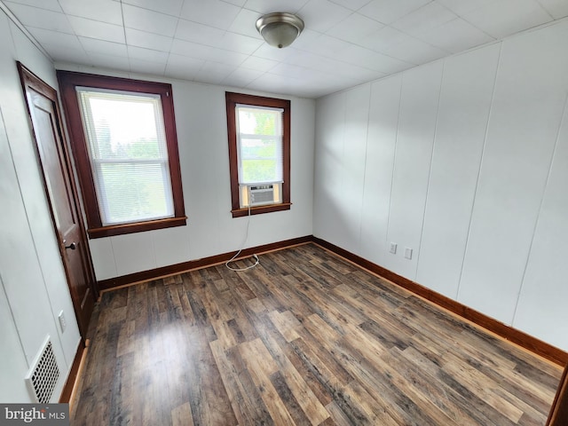 spare room with dark wood-type flooring and cooling unit