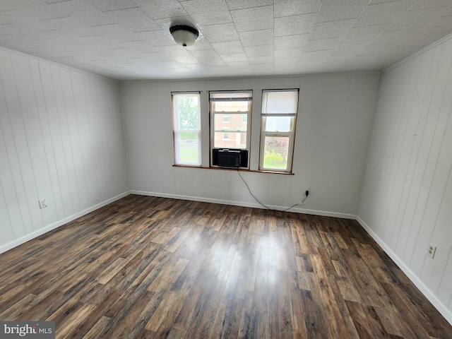 empty room with dark wood-type flooring and cooling unit