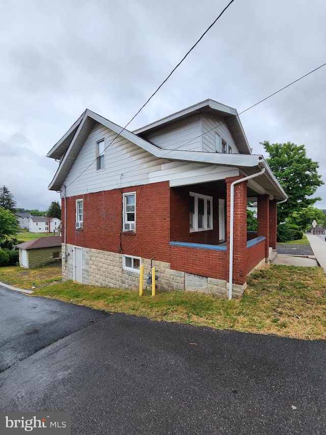 view of side of property with a porch