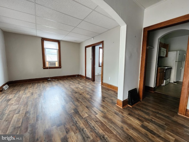 unfurnished room with a drop ceiling, dark hardwood / wood-style flooring, and cooling unit