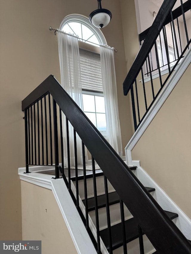 stairs featuring a high ceiling